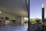 Doors, Exterior, Metal, and Sliding Door Type Set on sliders, the full-height glazed doors open up to seamlessly connect the art studio with the outdoors.    Photos from An Art Studio With Mirror-Like Glazing Floats Over a Desert Wash