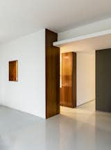 Hallway and Laminate Floor "Imbuia wood has a rich texture that contrasts with the floor and gives character to the surroundings," adds the firm.

  Photos from Greenery Breathes Fresh Life Into a Brazilian Midcentury
