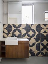 Local artist Teo Menna designed the pattern for the bathroom cement tile. "It is an old material that refers back to the time of the construction of the building, but was used with a more contemporary language," note the architects.

