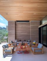 This outdoor room is flanked by rammed earth walls constructed from soil excavated on site.
