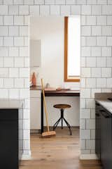 One wall of the kitchen is entirely clad in Heath Ceramics tile with a highly irregular glaze. 