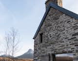 Exterior, Gable RoofLine, Stone Siding Material, and House Building Type New openings have been cut into the gables and the rear elevation to frame picturesque views and bring more natural light indoors.  Photo 3 of 13 in Cozy Up in a Nordic-Inspired Retreat Reborn From Ruins