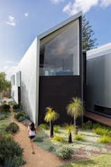 Exterior, Metal Roof Material, House Building Type, Metal Siding Material, and Shed RoofLine Three sizes of galvanized, corrugated iron-sheet panels were collaged along the street-facing southern facade.  Photo 3 of 17 in Water Slices Through This Gorge-Inspired Australian House