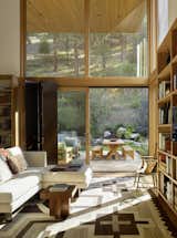 "The library space is positioned on the intimate courtyard nestled into the base of the butte," note the architects. "Here, an expressive, sheltering roof tilts up to capture natural light and rising views of the old-growth pine forest."

  Photo 2 of 12 in A Modern Montana House Mixes a Love of Art With the Outdoors