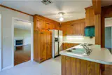 Before: the kitchen was wrapped in dark paneled wood and featured a very tight layout.