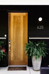 Doors, Wood, Exterior, and Swing Door Type A new entry was created with a door set at a slightly lower elevation than the original.  Photos from Before & After: A Nashville Midcentury Now Gleams With Natural Light