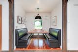 The banquette-style dining area features a built-in table and plush, leather seating.