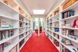 The main landing on the second floor of the West Wing is defined by a built-in library with recessed lighting. 