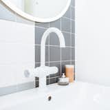 Bath Room, Wall Mount Sink, and Ceramic Tile Wall The plumbing fixtures are from Rubinet.  Search “k3” from Budget Breakdown: A Humdrum Bathroom Gets a Retro-Chic Facelift For $17K