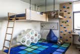 Bedroom, Medium Hardwood Floor, Bed, and Chair The clients' teenage son was given a more colorful bedroom with an elevated bed and a small climbing wall.   My Saves from An Energy-Conscious Home Gets Woven Into a Waterfront Landscape