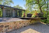 Branching off from the media room is the outdoor lounge, cantilevered over a split-face granite retaining wall. 