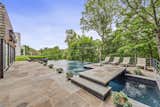 Outdoor, Stone, Back Yard, Trees, Infinity, Grass, Large, Large, Raised Planters, Swimming, Hanging, Horizontal, Shrubs, Metal, and Woodland The rear terrace boasts a recently built heated swimming pool with an infinity edge.  Outdoor Grass Woodland Infinity Large Photos from Favorites