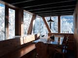 Dining Room, Medium Hardwood Floor, Pendant Lighting, Table, Chair, and Bench Water is sourced from local springs and waterfalls, and is then heated with a gas boiler.  Photo 13 of 121 in Dining by Casey Tiedman from Wake Up to Mountain Vistas in This Chic Chalet in Chile