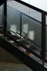 The staircase features walnut treads and black steel railings. 