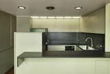 Kitchen, Dishwasher, Refrigerator, Drop In Sink, Wall Oven, and Cooktops The kitchen features original ergonomic cabinetry, trim work, and recessed lighting.

  Photo 10 of 14 in Own an Iconic Midcentury in Austin For Just Under $500K