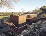 Outdoor, Walkways, Shrubs, Stone, Small, Boulders, Metal, Metal, Rooftop, and Trees The weathering steel exterior pays homage to the owner’s youth, which was spent welding oil tanks.

  Outdoor Trees Metal Rooftop Small Stone Photos from An Award-Winning Writing Studio Hides Quietly in Texas