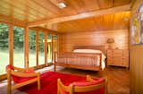 Bedroom, Dresser, Chair, Bed, Ceiling, and Concrete A second bedroom originally used as the master before Tarantino Architect's extension was built.  Bedroom Concrete Ceiling Dresser Photos from New Jersey’s Oldest and Largest Frank Lloyd Wright House Cuts Price to $1.45M