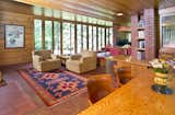 Living Room, Concrete Floor, Bench, Recessed Lighting, Table, Bookcase, and Chair Full-height glazed doors flood the interior with natural light and open up to an outdoor brick terrace.  Photo 4 of 12 in New Jersey’s Oldest and Largest Frank Lloyd Wright House Cuts Price to $1.45M