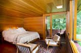 Bedroom, Table, Bed, Concrete, Ceiling, and Chair The master bedroom suite realized by Tarantino Architect opens up to an enclosed brick patio.  Bedroom Concrete Chair Table Ceiling Photos from New Jersey’s Oldest and Largest Frank Lloyd Wright House Cuts Price to $1.45M