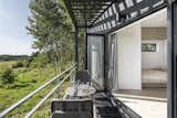 Doors, Exterior, Metal, and Folding Door Type Folding glass doors blur the boundaries between the indoors and out.   Photo 4 of 11 in Mingle With Mother Nature in This Tiny Prefab Getaway