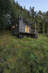 Exterior, Cabin Building Type, Concrete Siding Material, and Flat RoofLine The Etno Hut is elevated on a steel foundation screwed into the ground by hand. The space beneath the main volume was covered to hide cables, piping, and storage.    Photo 3 of 11 in Mingle With Mother Nature in This Tiny Prefab Getaway
