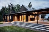 "The roof that connects the two volumes makes it possible to use the patio even when it rains or when the dew settles," note the architects. "This way the house is adapted for Swedish summer— it works in all kinds of weather."