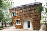 Exterior, Shingles, Wood, House, Small Home, and Gable The one-bedroom abode features a wood-and-steel frame clad in oversized cedar shakes repurposed from the roof of another home.   Exterior Shingles Gable Small Home Wood Photos from A Whimsical Guest House Leans Out to Maximize Space