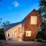 Exterior, Shingles, Wood, House, Gable, Small Home, and Shed The Hive was completed in May 2015 for a total construction cost of $160,000.  Exterior Shingles Small Home Photos from A Whimsical Guest House Leans Out to Maximize Space