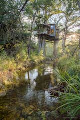Exterior, Metal, Treehouse, Flat, and Metal Elevated above a spring-fed creek, Yoki draws inspiration from the "healing powers of water."  Exterior Metal Flat Treehouse Metal Photos from Escape to the Texan Treetops in This Eco-Luxe Treehouse