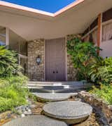 Doors, Wood, Swing Door Type, and Exterior The highly geometric house is dominated by circular motifs, but also features other unusual shapes, such as the pentagonal front porch and the boomerang-shaped roof.

  Photo 1 of 9 in Snag the Elvis Honeymoon Hideaway For the Reduced Price of $2.7M