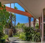 Outdoor, Shrubs, Trees, Hardscapes, Small, Stone, Front Yard, and Grass Landscaped with palms and other leafy greens, the house feels like a tropical paradise.   Outdoor Stone Small Grass Trees Photos from Snag the Elvis Honeymoon Hideaway For the Reduced Price of $2.7M