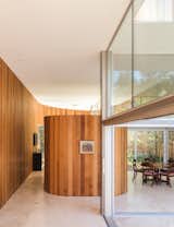 The kitchen pantry is housed in a curved, free-standing structure that's also wrapped in Western Red Cedar.