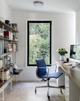 The office, located adjacent the master bedroom, is smartly outfitted with a vintage Aluminum Group Management chair by Herman Miller, a custom walnut plywood desk by Kerf Design, and Hitch bookcases from Blu Dot.