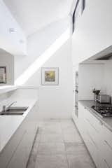 The white kitchen is equipped with NEFF appliances as well as Caesarstone Snow and stainless-steel countertops.
