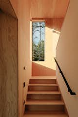 The light-filled stairway leads up to the an office and master bedroom. 