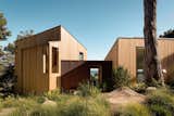 Corrugated Cor-Ten steel clads the entryway that connects the two cedar-clad wings. 