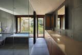 The minimalist bathrooms feature Silestone quartz countertops and tiled floors.
