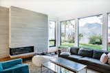 Board-formed concrete punctuates the home, including in the living room, where it frames the fireplace. The sofa is by Montauk. 
