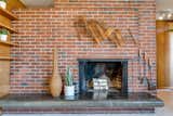 A masonry core at the heart of the home features a cantilevered, polished concrete hearth that has naturally darkened with age.