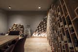 The new wine cellar references jagged mountain peaks with its geometric wooden shelving.