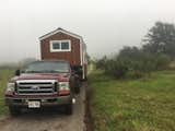 Set on wheels, the 350-square-foot tiny house can be towed with a truck. Despite the mobile nature of the dwelling, the couple installed drywall to achieve a smooth, clean finish on the interior; a few cracks did appear after moving the home but the couple both agree the drywall was worth it.  Photo 4 of 15 in Budget Breakdown: A Maui Couple Build an Off-Grid Tiny Home For $45K