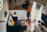 Living, Medium Hardwood, Coffee Tables, Sofa, Rug, Bench, Shelves, End Tables, and Wall Custom-built from the ground up, a 360-square-foot tiny house on wheels is an affordable, off-grid paradise for a family of three in Hawaii.  Living Bench Rug Shelves Photos from Budget Breakdown: A Maui Couple Build an Off-Grid Tiny Home For $45K