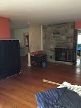 The stone surrounding the fireplace was one of Claude's least favorite aspects of the original house.