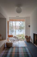 Behind the double-sided fireplace is an intimate reading room alcove with a stellar view of Candlewood Lake. The chair is a vintage Flag Halyard chair.