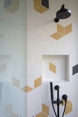 The kids' bathroom and entry bathroom sport colorful, geometric tile for a playful touch.