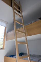 A ladder leads to the high-lofted bunk bed.