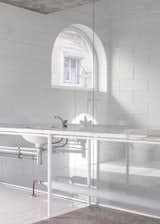 The marble counter morphs from a desk on the right-hand side to a sink next to the bathroom. 