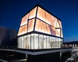 A lighthouse of cutting-edge digital fabrication, the building glows like a beacon at night. 