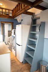 A bookcase ladder provides access to the double loft space above. 