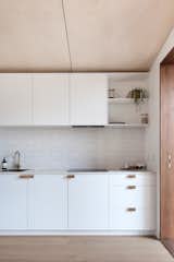 In the 236-square-foot studio is a kitchen dressed in a minimalist palette. 